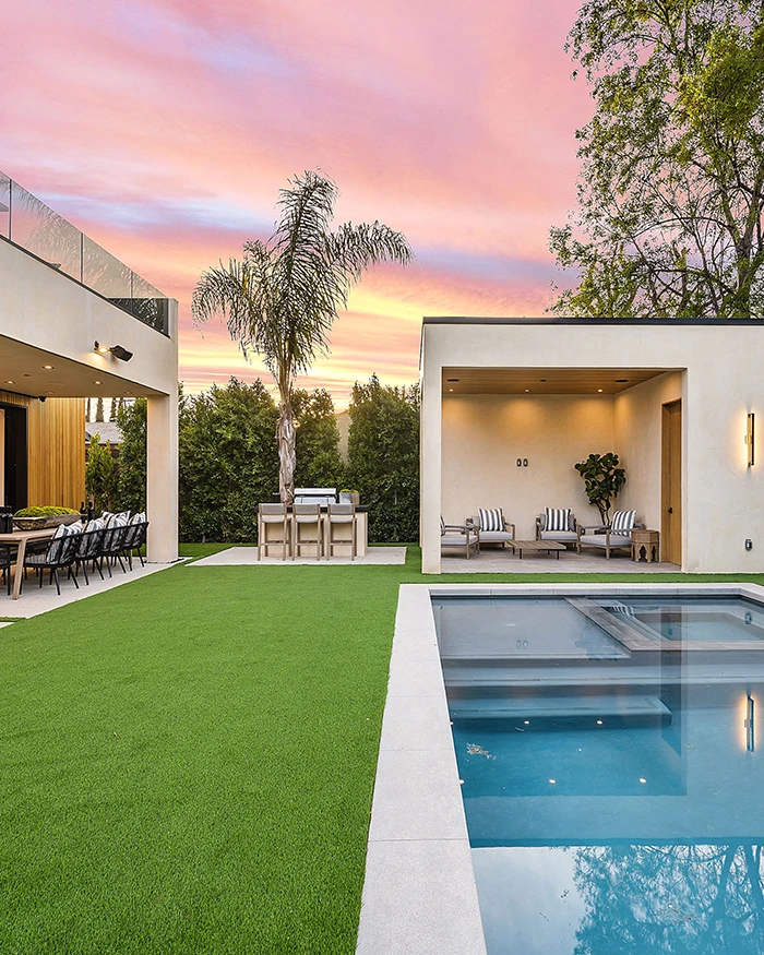 backyard pool with artificial turf and outdoor living area