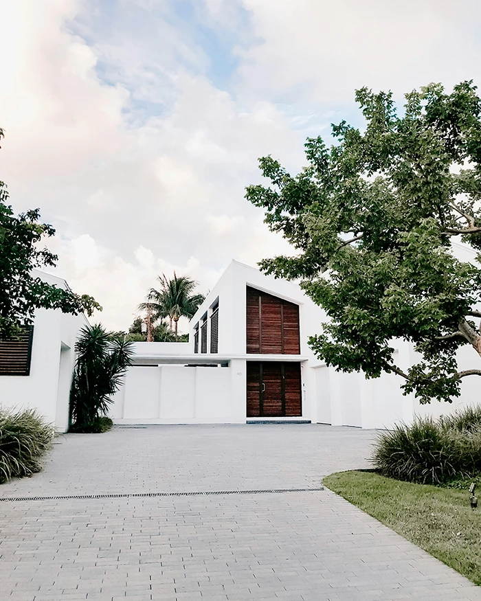 concrete driveway of a white modern house