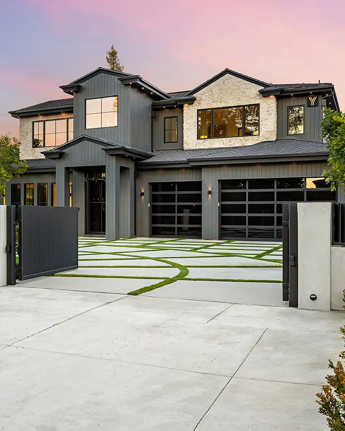 modern luxury home with landscaped driveway