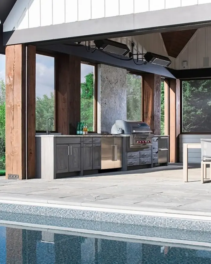 outdoor kitchen beside a backyard pool