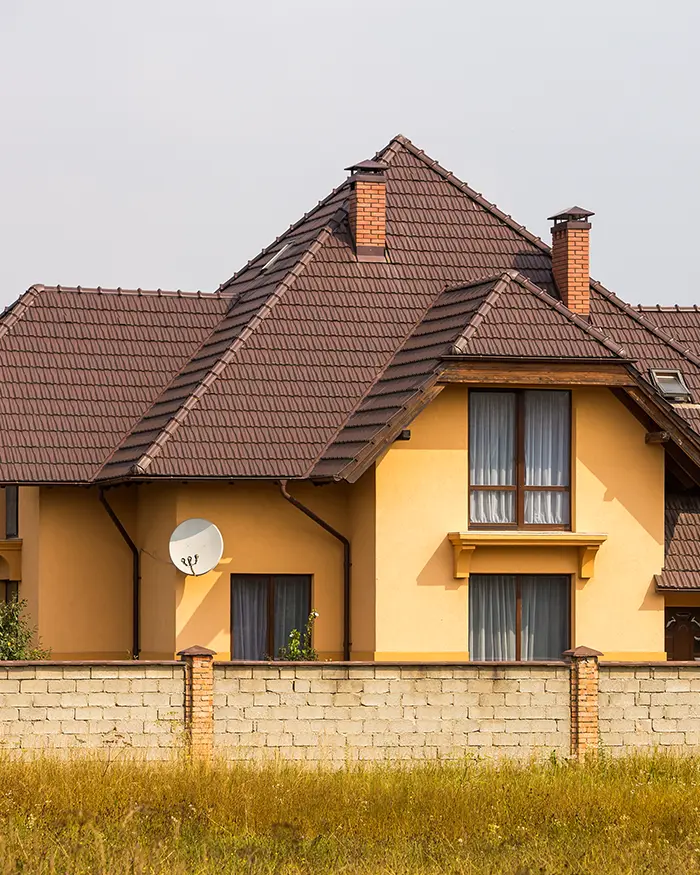 two-storey cottage with steep shingle roofing